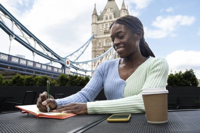 portrait-young-woman-with-afro-dreadlocks-city-having-coffee